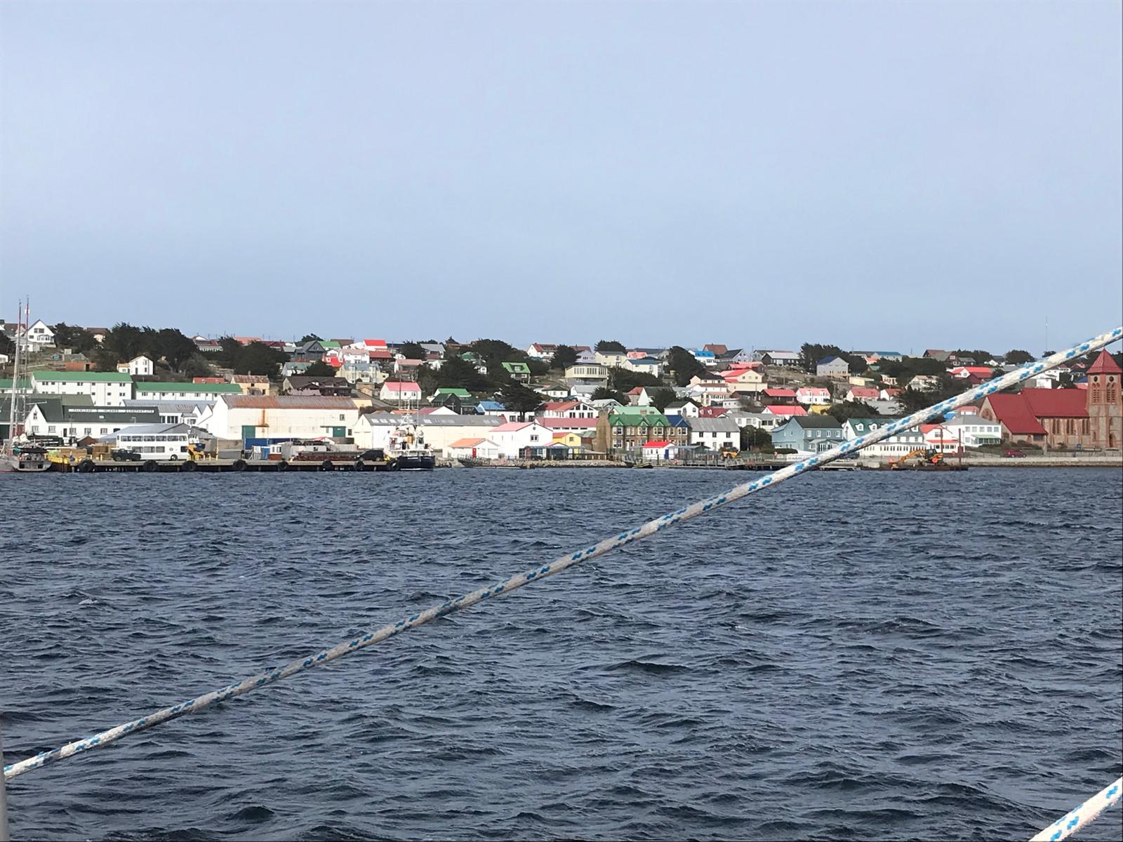 Stanley from the water: the front, the jetties, the cathedral roof at the right of frame.