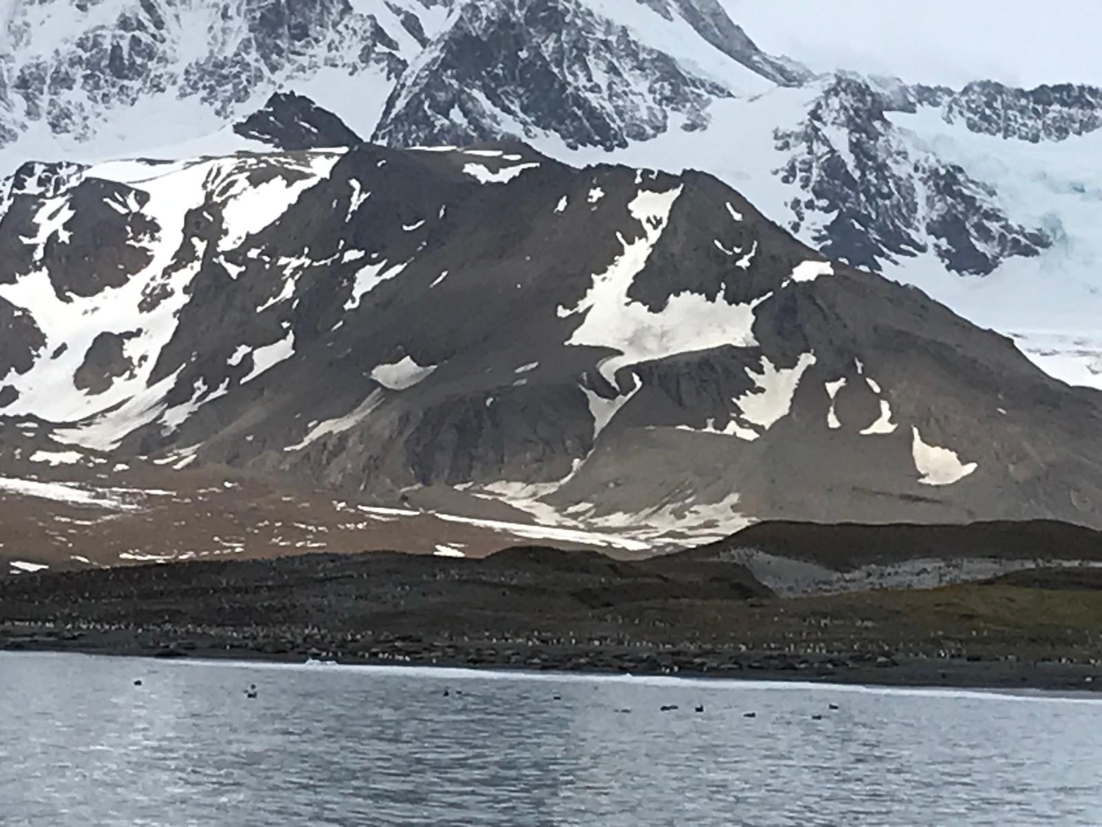 The same coast further along, under a hanging glacier.