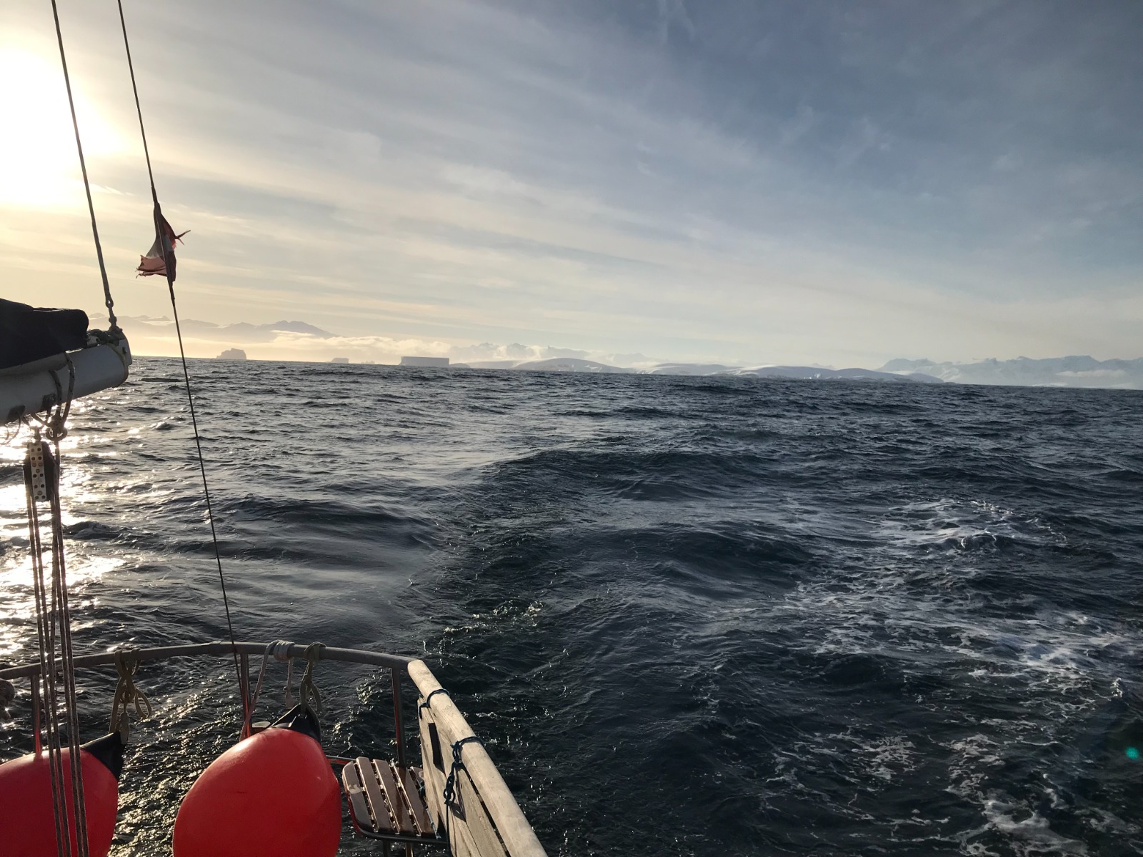 Running down towards the ice. Tabular bergs on the horizon, ensign streaming, fenders still on deck from the last harbour.